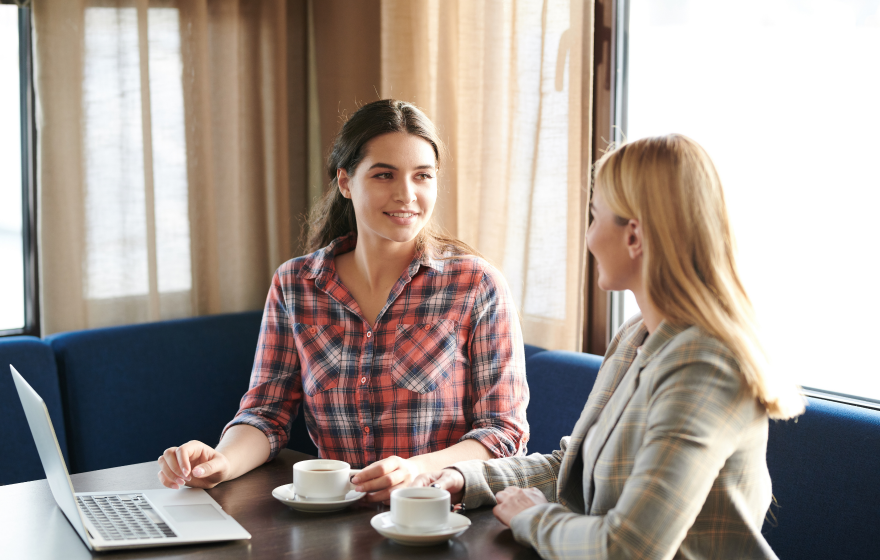 Two women talking over a coffee
