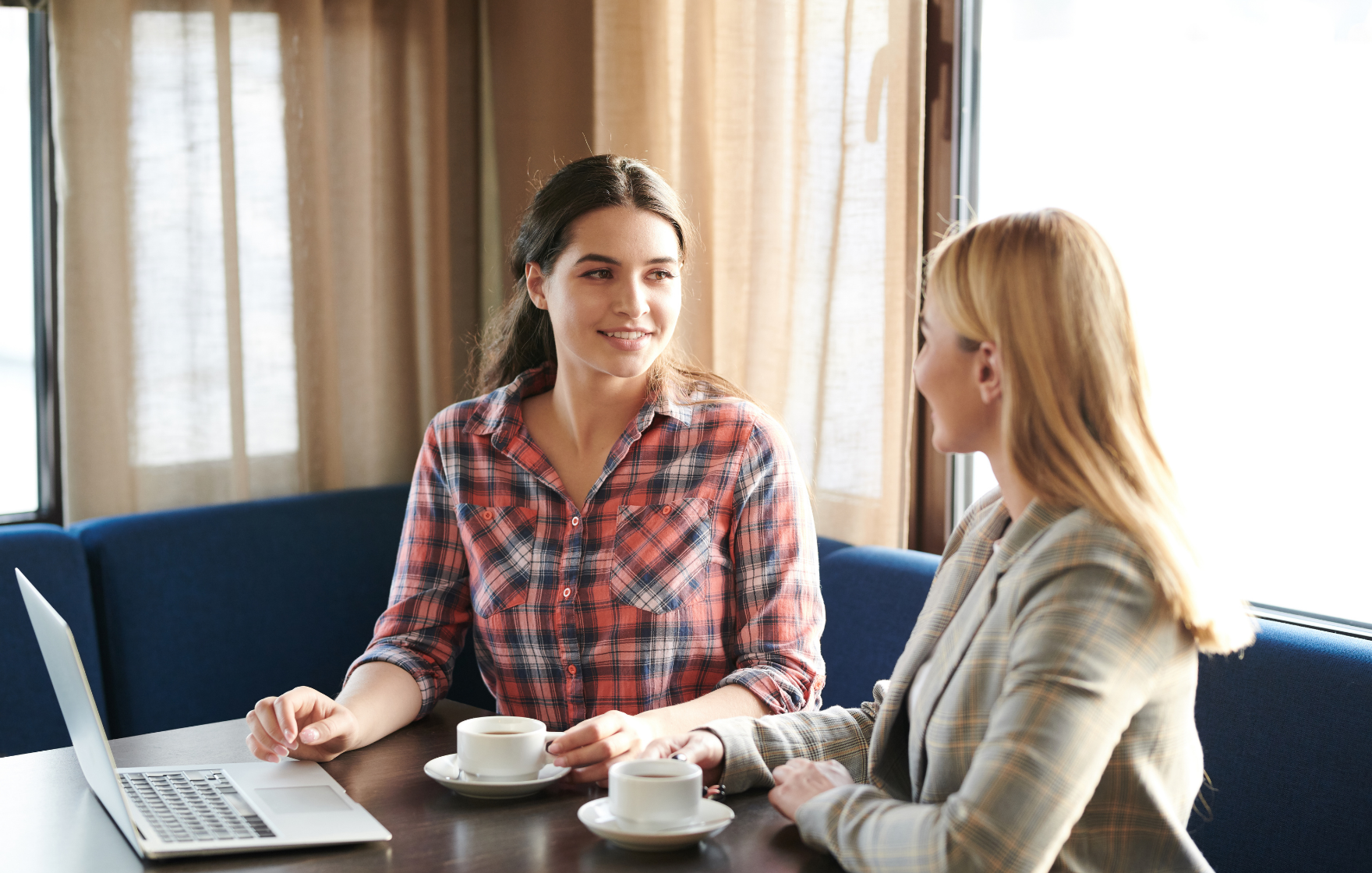 Two women talking over a coffee
